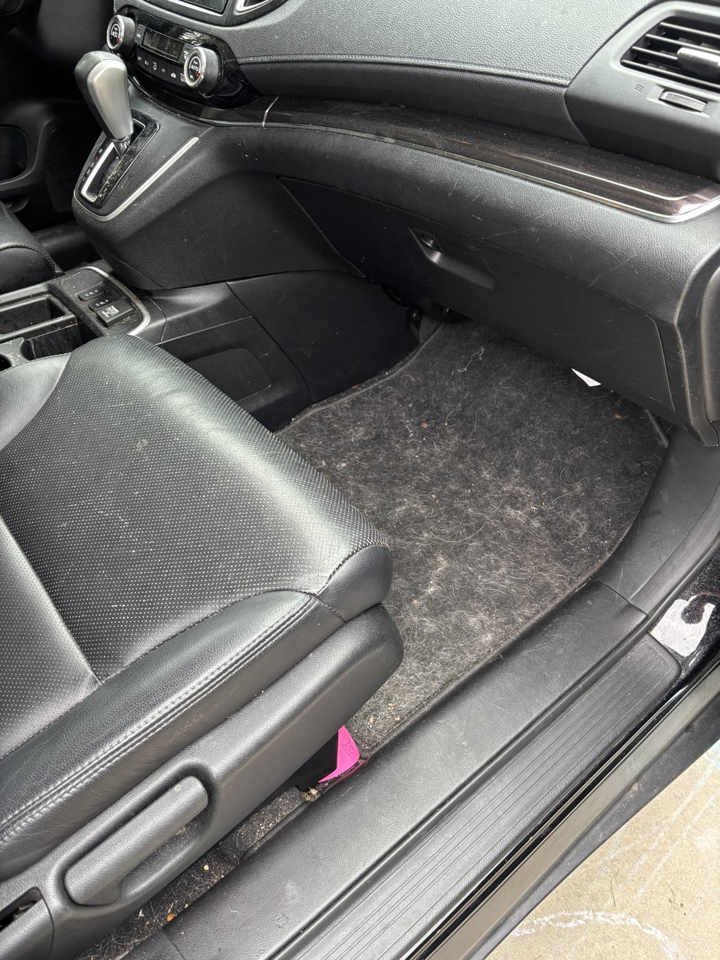 Passenger floor covered in pet hair before detailing
