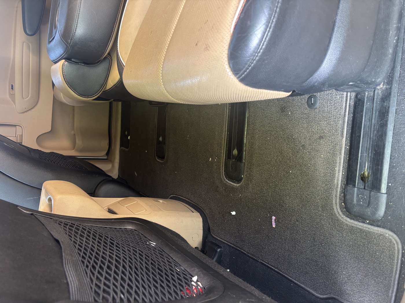 Second row carpet with crumbs and debris before detailing