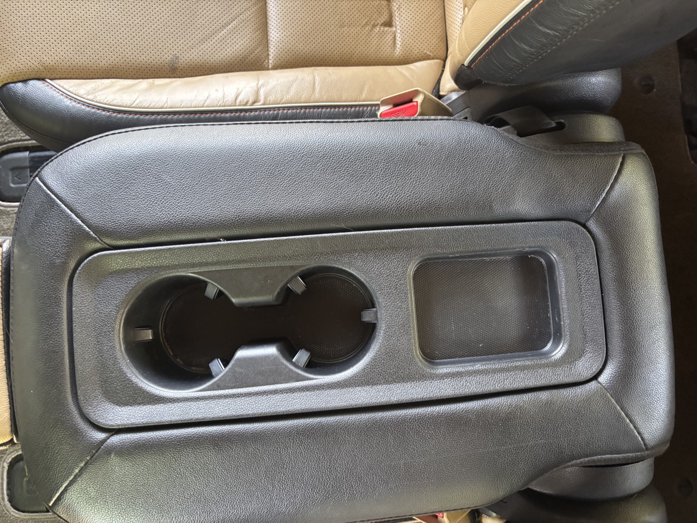 Rear seat cup holder console fully cleaned after detailing